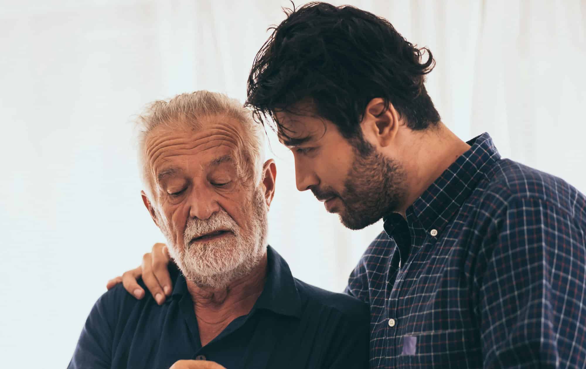 son and elderly father having a conversation