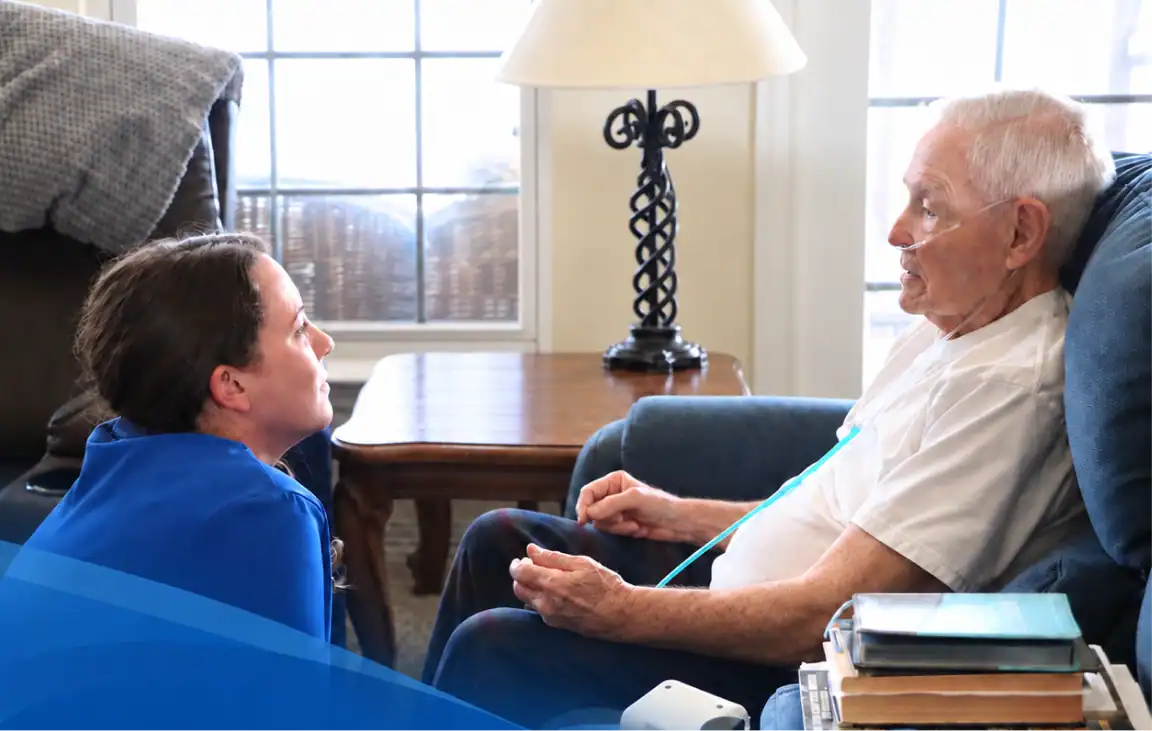 Healthcare professional assisting elderly patient with leg exercise